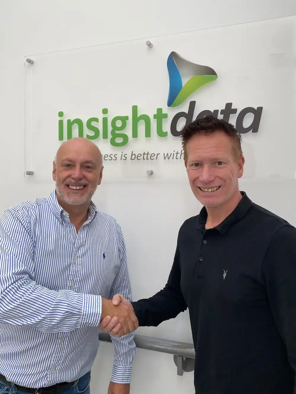 Jason Scrivens of Swiftframe shaking hands with Andrew Scott of Insight Data.
